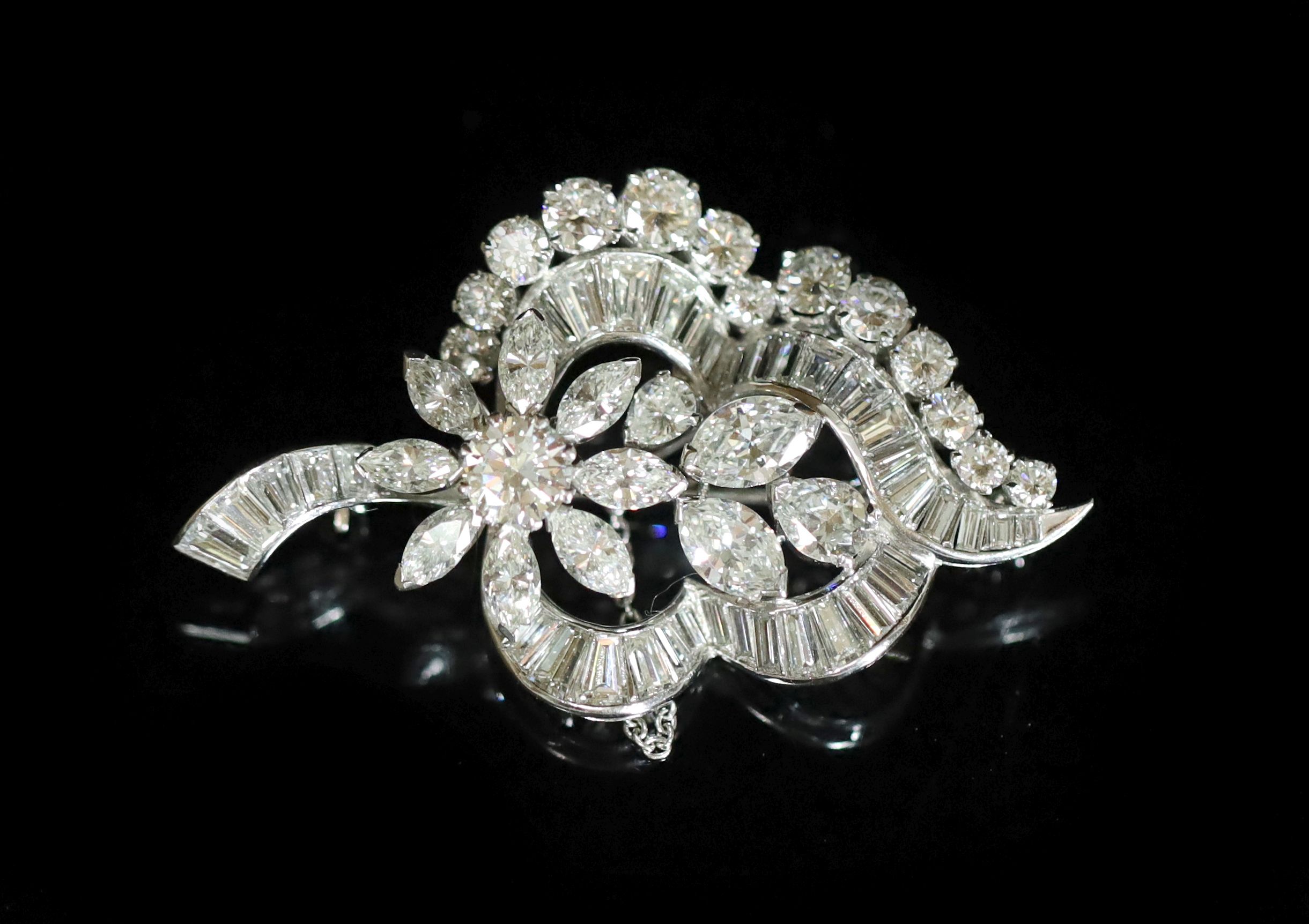 A 1960's white gold and diamond flower design brooch,